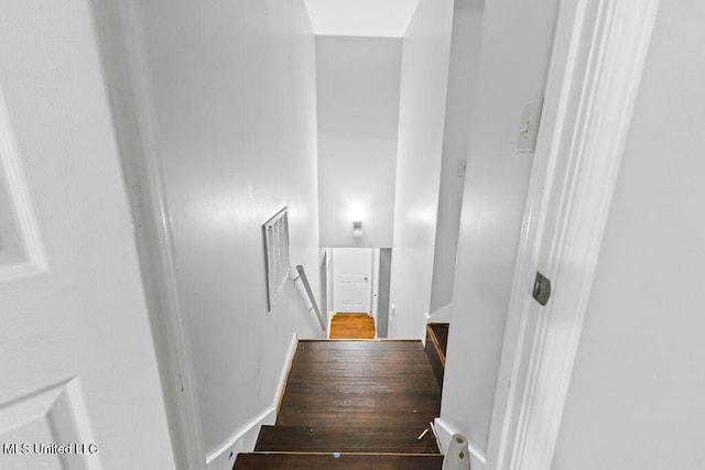 stairway featuring wood finished floors