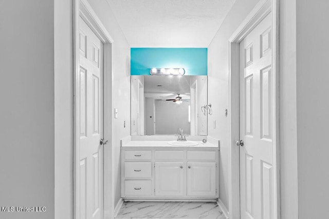 bathroom featuring vanity, baseboards, a ceiling fan, and marble finish floor