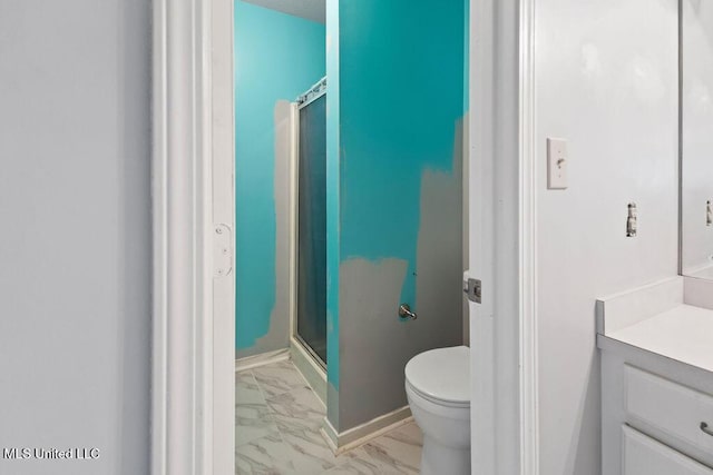 full bathroom with a stall shower, marble finish floor, vanity, and toilet