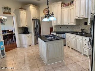 3808 Acadian Village Dr, Ocean Springs, MS 39564 - kitchen featuring stainless steel appliances, a chandelier, dark countertops, and light tile patterned floors