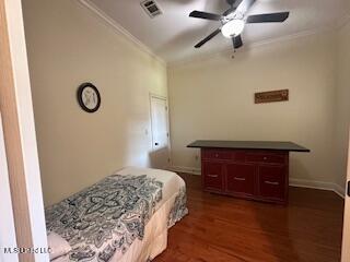 3808 Acadian Village Dr, Ocean Springs, MS 39564 - bedroom with ornamental molding, dark wood finished floors, ceiling fan, and baseboards