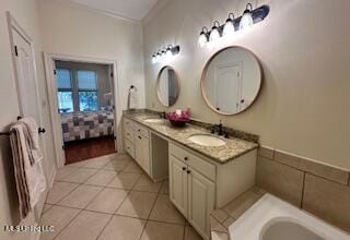 3808 Acadian Village Dr, Ocean Springs, MS 39564 - ensuite bathroom featuring tile patterned floors, vanity, a bathtub, and crown molding