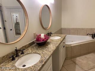 3808 Acadian Village Dr, Ocean Springs, MS 39564 - bathroom with double vanity, a garden tub, and tile patterned flooring