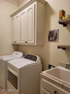 3808 Acadian Village Dr, Ocean Springs, MS 39564 - clothes washing area with independent washer and dryer, cabinet space, and crown molding