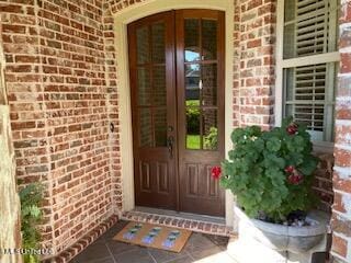 3808 Acadian Village Dr, Ocean Springs, MS 39564 - property entrance with brick siding and french doors