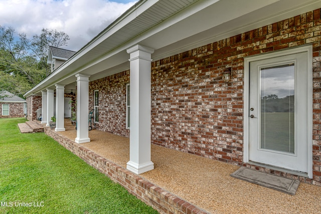 property entrance with a lawn and a porch