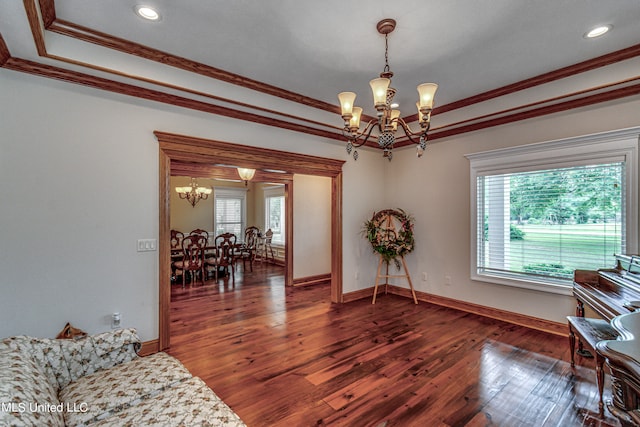 sitting room with ornamental molding, a notable chandelier, dark hardwood / wood-style floors, and a tray ceiling