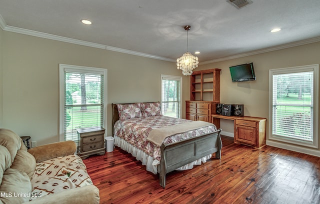 bedroom with an inviting chandelier, crown molding, and dark hardwood / wood-style flooring