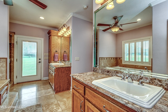 bathroom featuring tile patterned flooring, crown molding, vanity, a bath, and ceiling fan