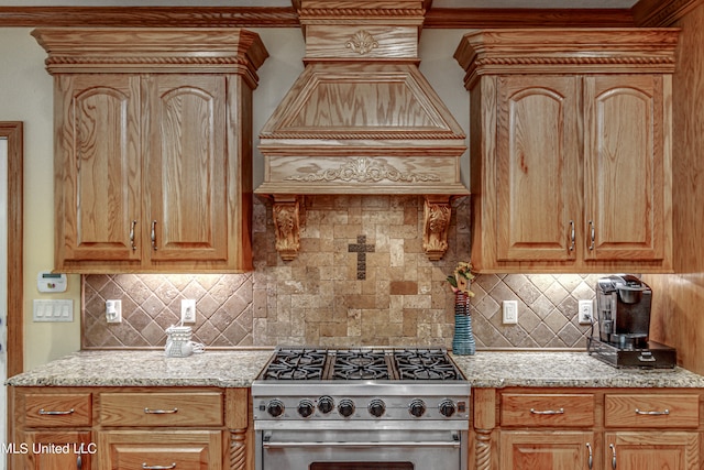 kitchen featuring light stone countertops, backsplash, high end stainless steel range oven, and custom exhaust hood