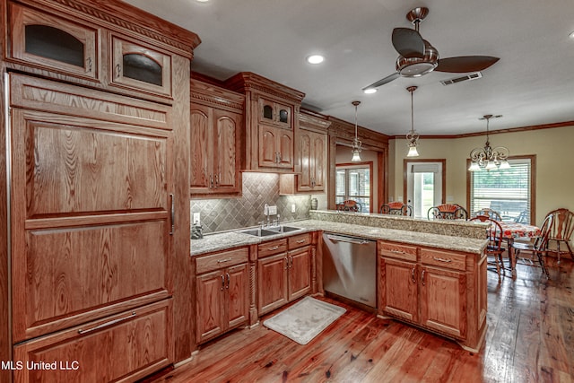 kitchen featuring dishwasher, light wood-type flooring, ceiling fan with notable chandelier, hanging light fixtures, and crown molding