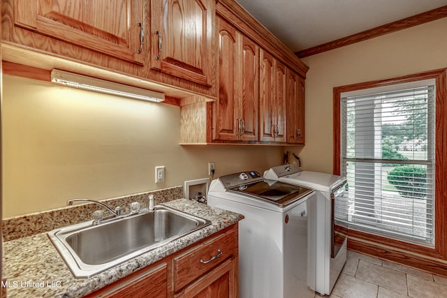 clothes washing area with washer and clothes dryer, ornamental molding, sink, light tile patterned floors, and cabinets