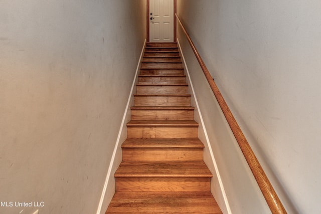 stairs with hardwood / wood-style floors