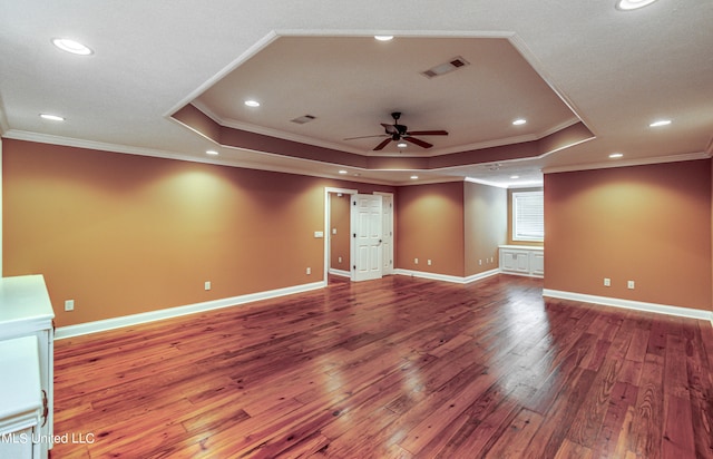 unfurnished room featuring ceiling fan, crown molding, a raised ceiling, and hardwood / wood-style floors