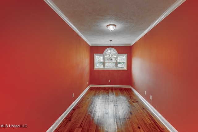 interior space with crown molding, hardwood / wood-style flooring, a textured ceiling, and a chandelier