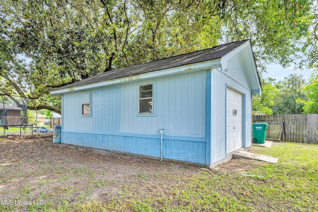 view of outbuilding with a lawn and a garage