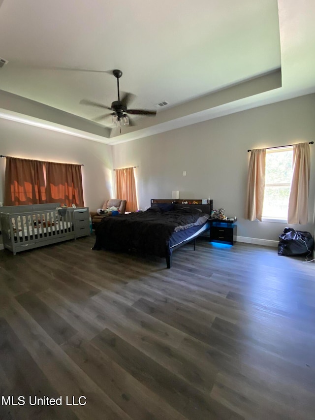 bedroom featuring ceiling fan and dark hardwood / wood-style flooring