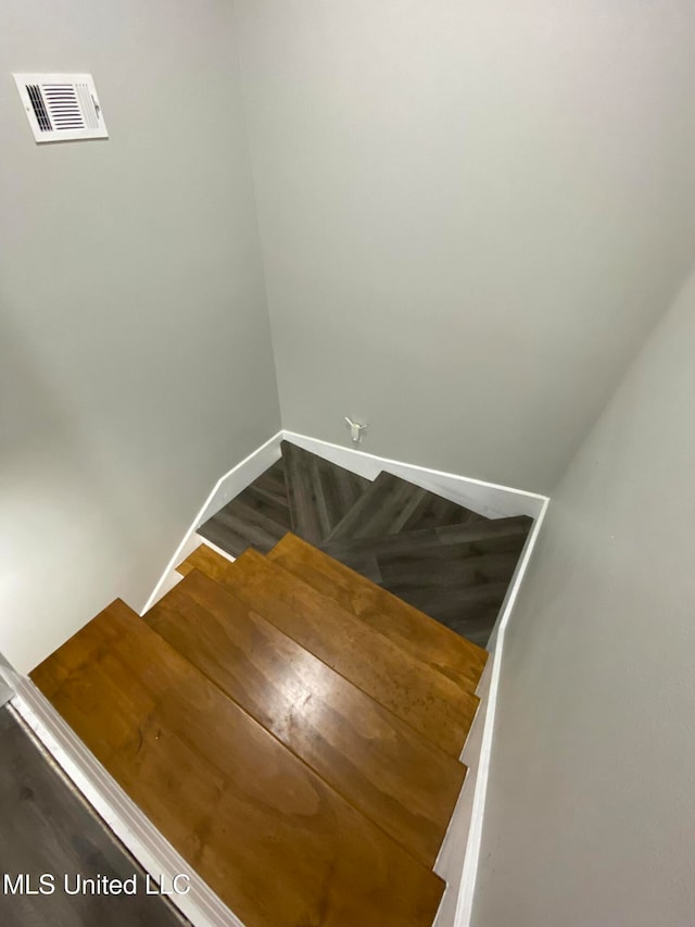 stairway with hardwood / wood-style flooring