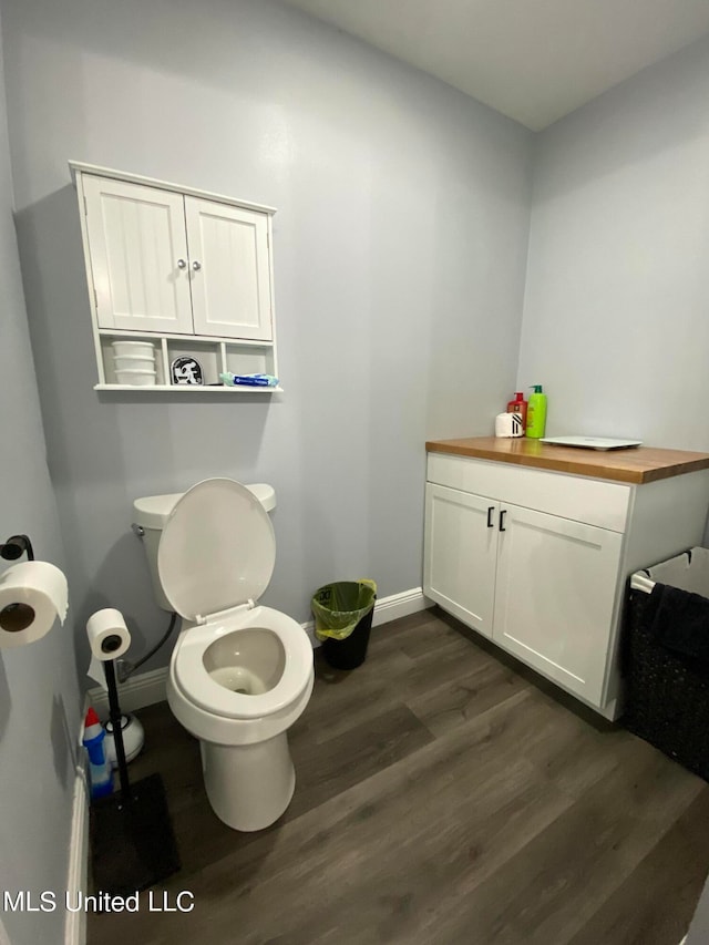 bathroom with wood-type flooring and toilet