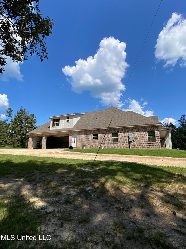 rear view of house featuring a lawn