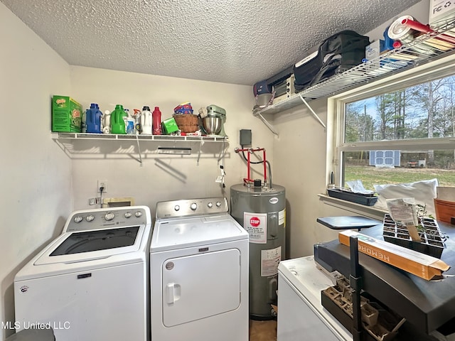 laundry room with laundry area, electric water heater, a textured ceiling, and washing machine and clothes dryer