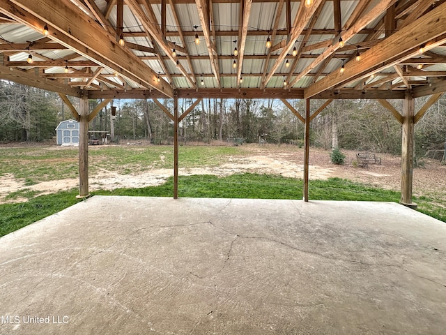 view of patio / terrace featuring a storage unit and an outdoor structure