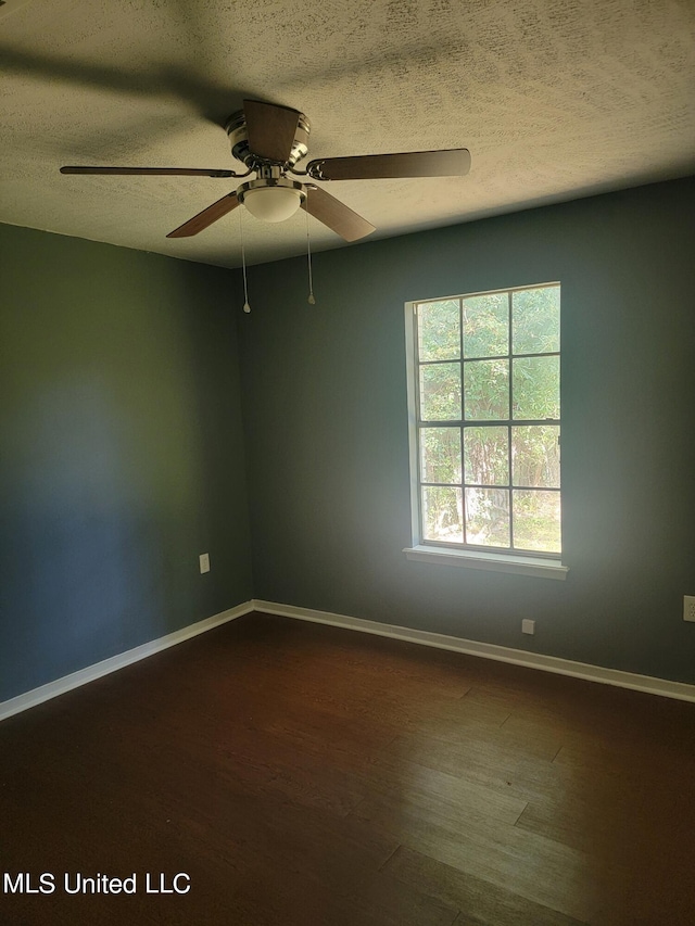 spare room with hardwood / wood-style floors, a textured ceiling, and ceiling fan