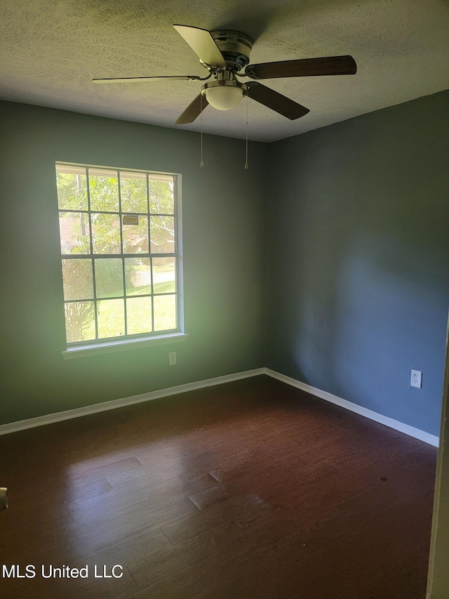 unfurnished room with a textured ceiling, wood-type flooring, and ceiling fan