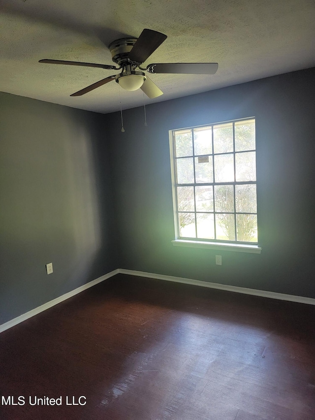 spare room featuring a textured ceiling and ceiling fan