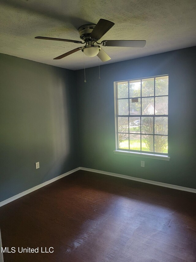 unfurnished room with a textured ceiling, hardwood / wood-style flooring, and ceiling fan