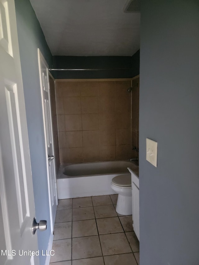 full bathroom featuring vanity, tiled shower / bath combo, toilet, and tile patterned floors