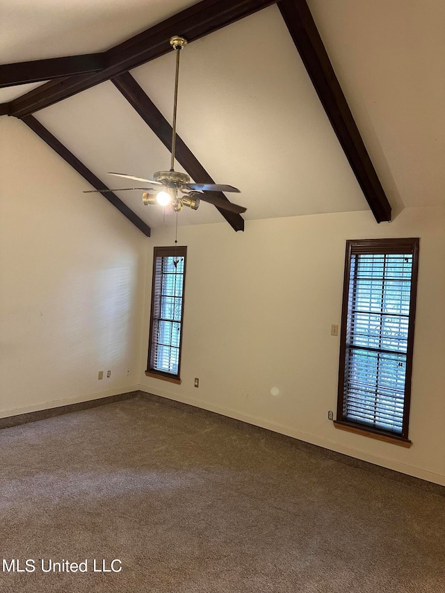 empty room featuring ceiling fan, a healthy amount of sunlight, and lofted ceiling with beams