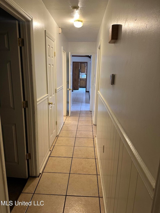 hall featuring light tile patterned flooring