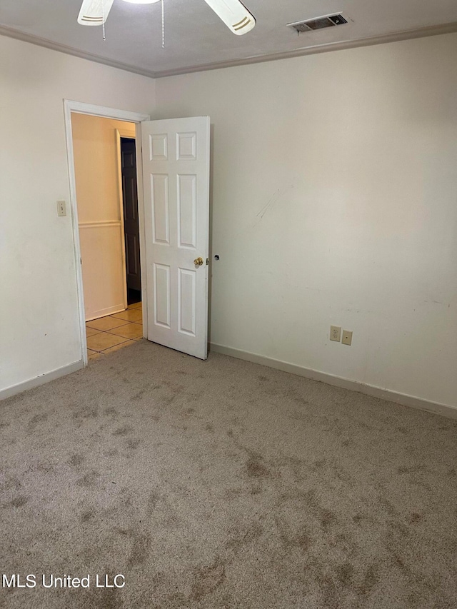 unfurnished room with light carpet, ornamental molding, and ceiling fan