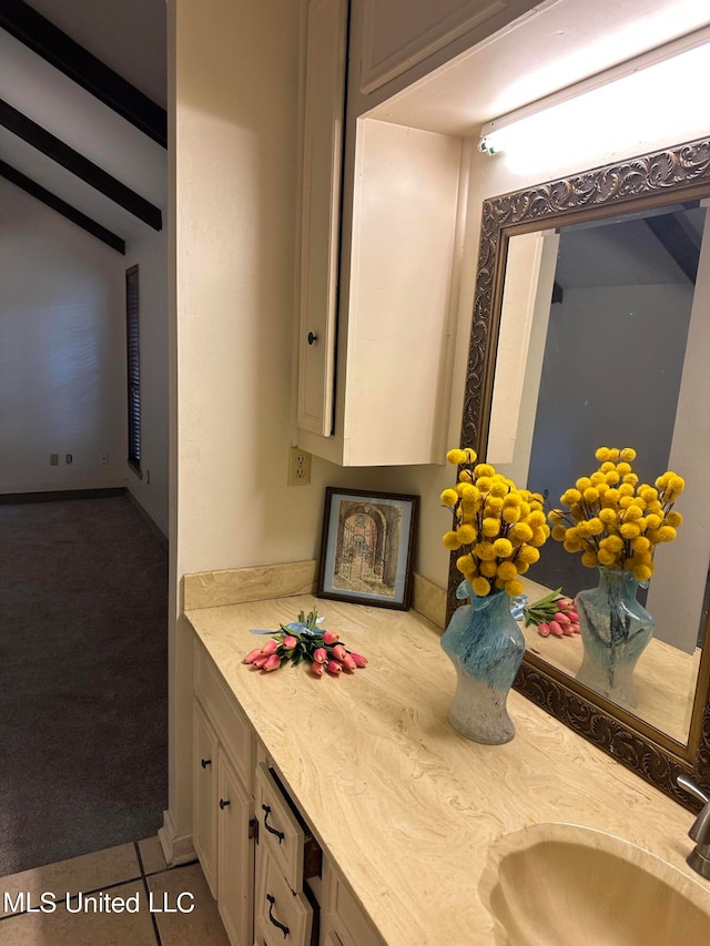 bathroom featuring vanity, vaulted ceiling with beams, and tile patterned flooring