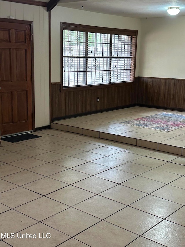 tiled entryway with wooden walls