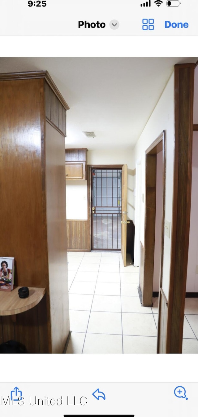 corridor with light tile patterned flooring