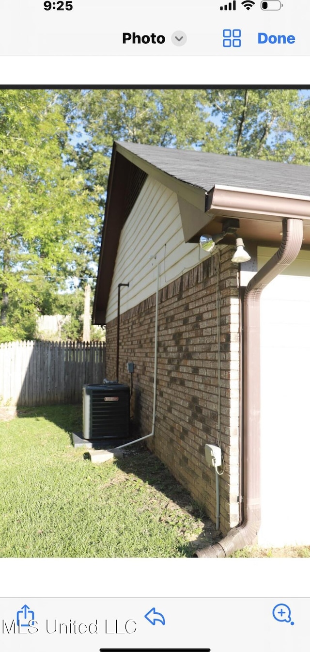 view of home's exterior with central air condition unit and a lawn