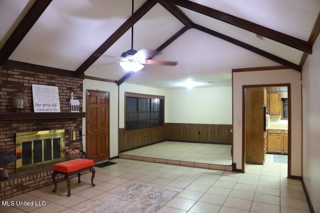 tiled living room featuring ceiling fan, lofted ceiling with beams, wooden walls, and a fireplace