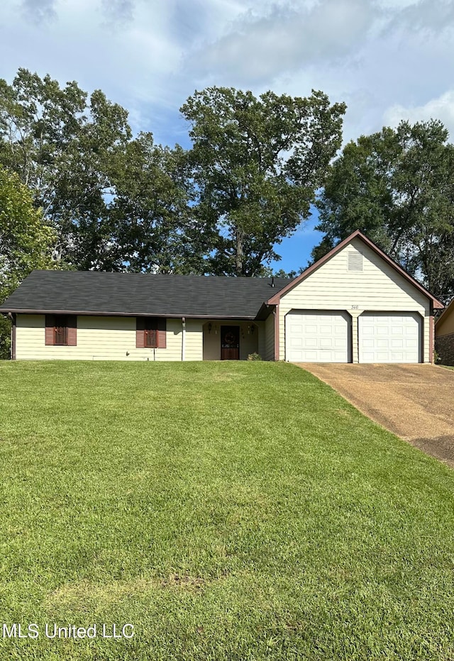 ranch-style house featuring a front yard and a garage