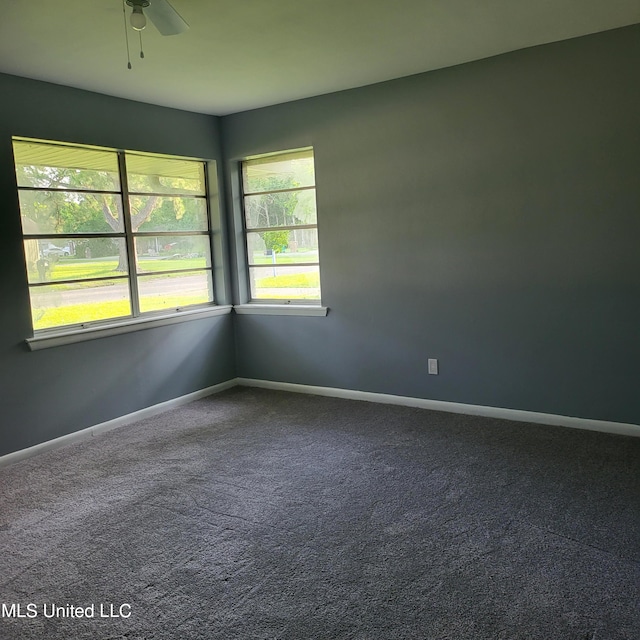 carpeted spare room with ceiling fan