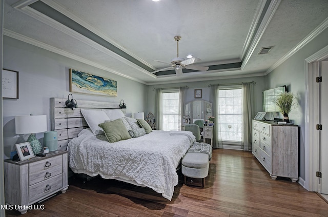 506 Ridge Cir, Brandon, MS 39047 - bedroom featuring dark wood-style floors, crown molding, a raised ceiling, and ceiling fan