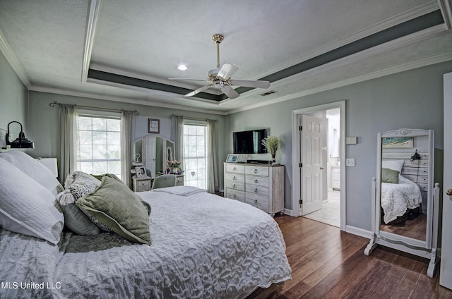 506 Ridge Cir, Brandon, MS 39047 - bedroom with dark wood-type flooring, a tray ceiling, ornamental molding, and ceiling fan