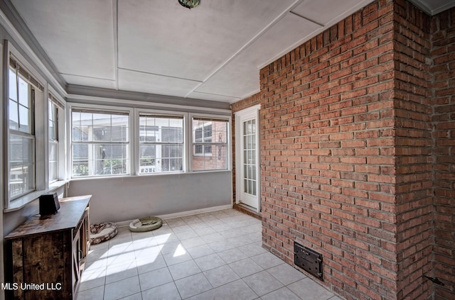 506 Ridge Cir, Brandon, MS 39047 - unfurnished sunroom with brick wall and tile patterned floors