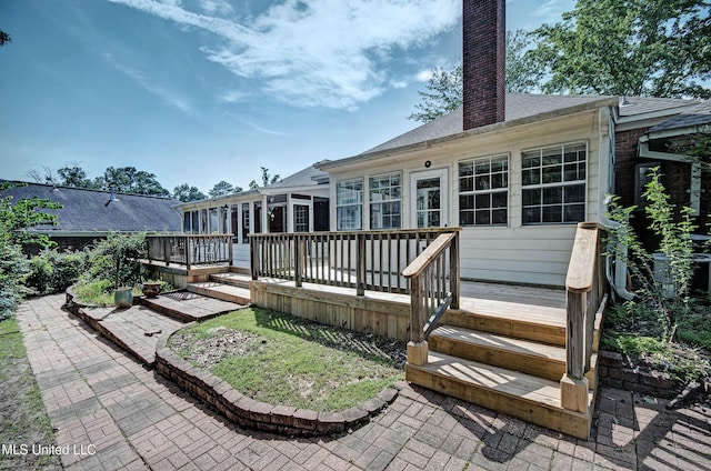 506 Ridge Cir, Brandon, MS 39047 - rear view of house featuring a chimney, a deck, a patio, and roof with shingles