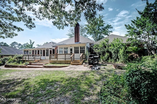 506 Ridge Cir, Brandon, MS 39047 - rear view of house with a wooden deck, a chimney, a lawn, a sunroom, and a patio