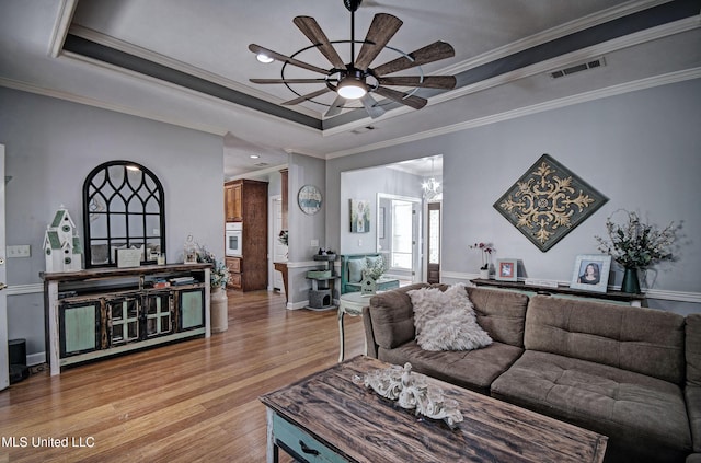 506 Ridge Cir, Brandon, MS 39047 - living room featuring a ceiling fan, light wood finished floors, a raised ceiling, crown molding, and recessed lighting