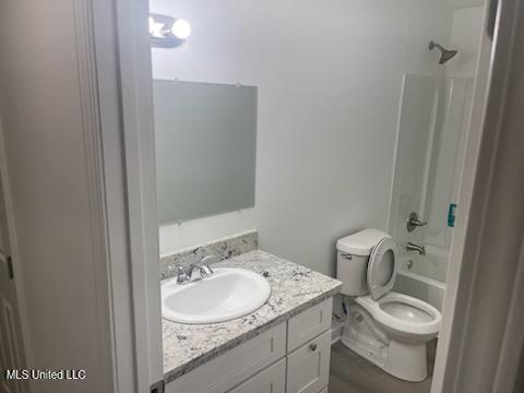 full bathroom featuring vanity, hardwood / wood-style floors, toilet, and shower / bath combination