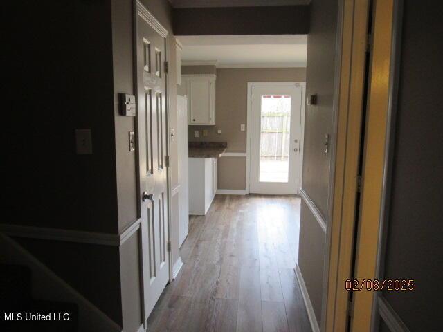 hallway with hardwood / wood-style flooring