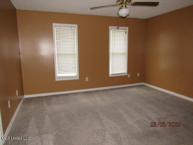 unfurnished room with ceiling fan, a healthy amount of sunlight, and carpet flooring